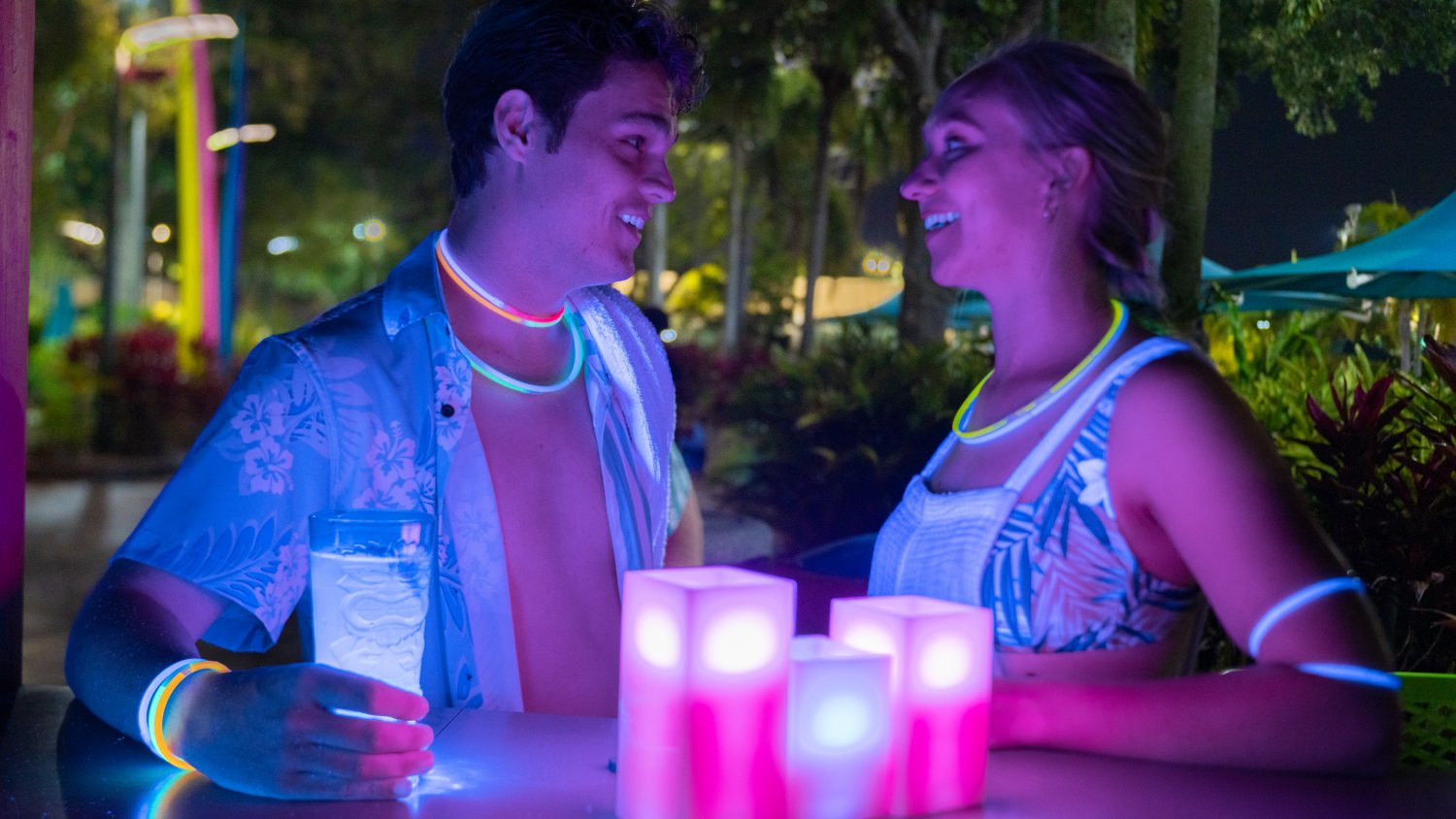 Two people with cocktails at night