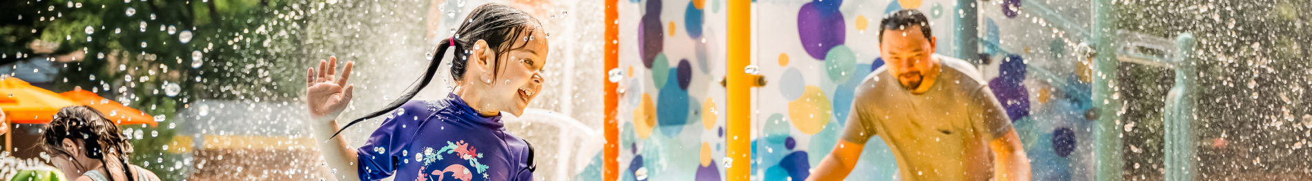 Girl playing in lil surfers splash pad