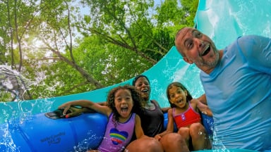 A Family riding Big Daddy Falls at Water Country USA.