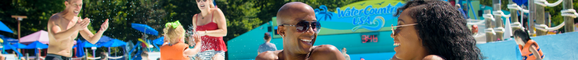 Family Enjoying Surfers Bay Wave Pool at Water Country USA.